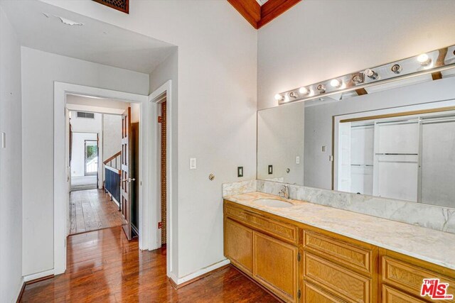 bathroom with vanity and hardwood / wood-style floors