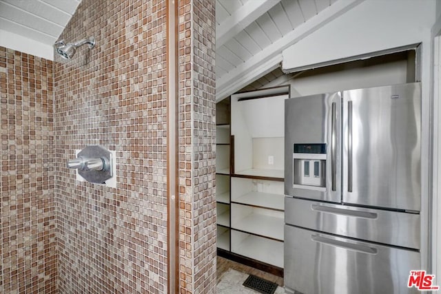 kitchen with lofted ceiling and stainless steel fridge with ice dispenser