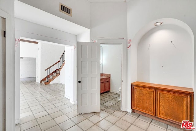 hall featuring light tile patterned floors