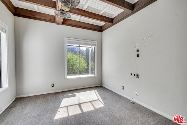 empty room with beamed ceiling and carpet flooring