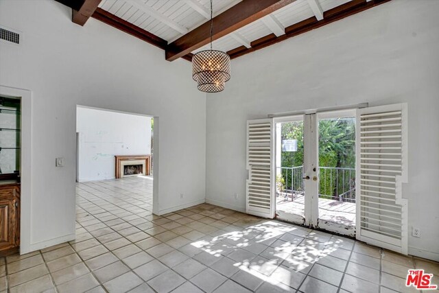 unfurnished living room featuring light tile patterned floors, wood ceiling, french doors, high vaulted ceiling, and beamed ceiling