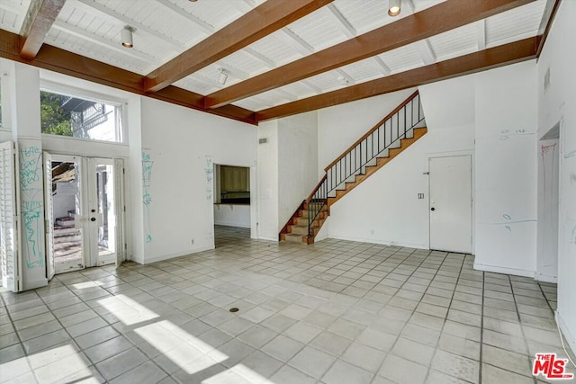 unfurnished living room featuring wooden ceiling, light tile patterned floors, beam ceiling, and high vaulted ceiling