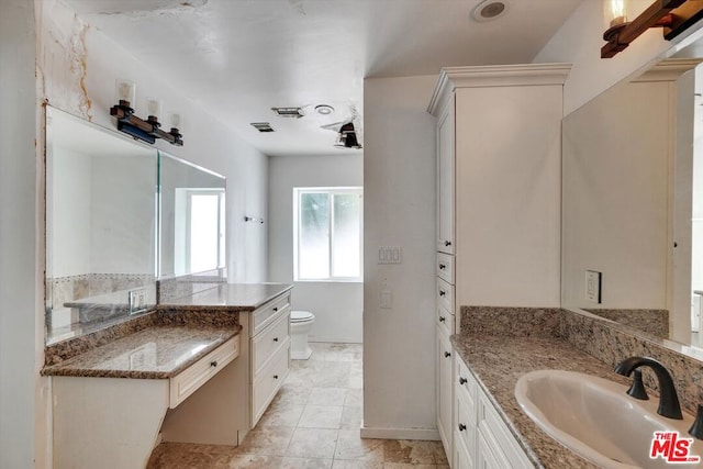 bathroom featuring toilet and vanity