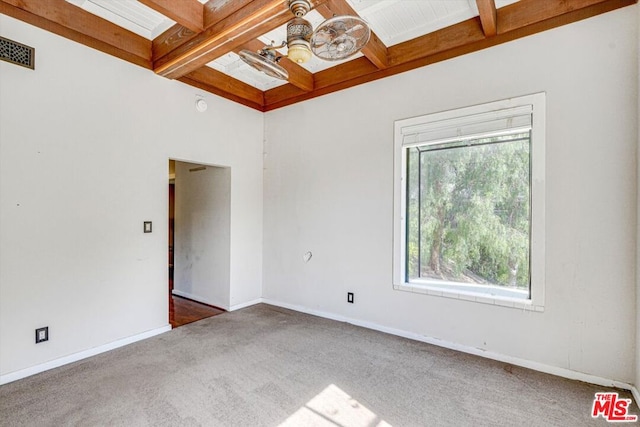 unfurnished room featuring beamed ceiling, coffered ceiling, and dark carpet