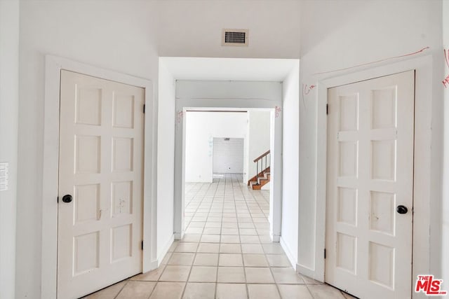 hallway featuring light tile patterned floors