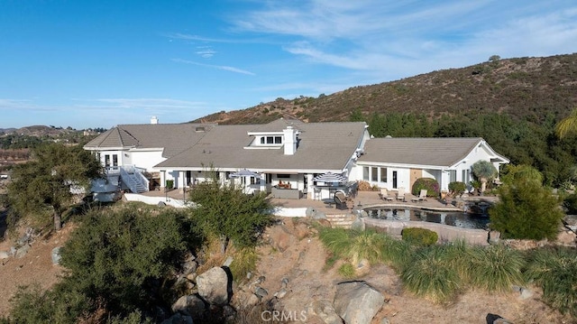 exterior space featuring a mountain view and a patio