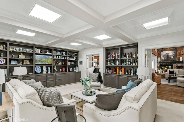 living room with coffered ceiling, bar area, crown molding, beam ceiling, and built in shelves