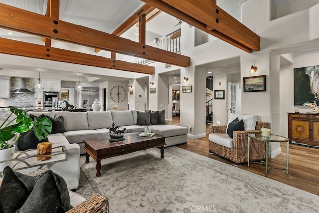 living room featuring a high ceiling and hardwood / wood-style flooring