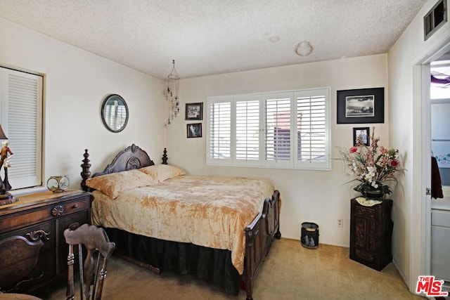 carpeted bedroom with a textured ceiling