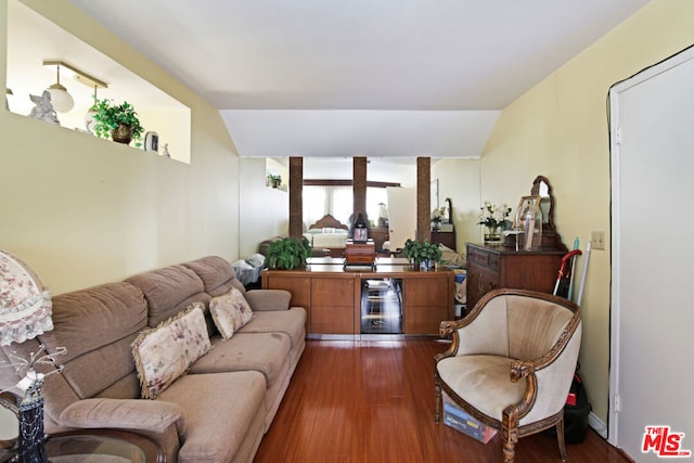 living room with wine cooler, dark hardwood / wood-style flooring, and lofted ceiling