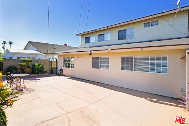 rear view of property featuring a patio