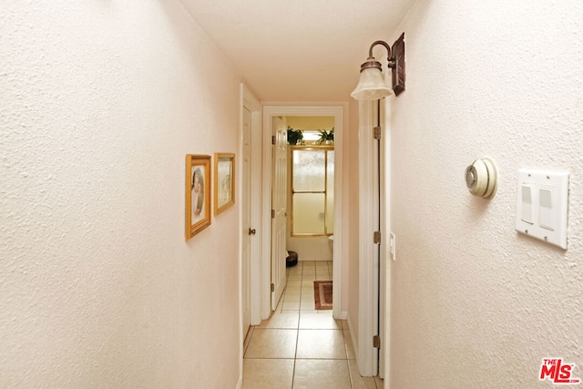 hallway featuring light tile patterned floors