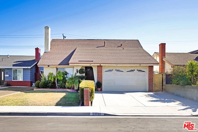 ranch-style house with a front lawn and a garage