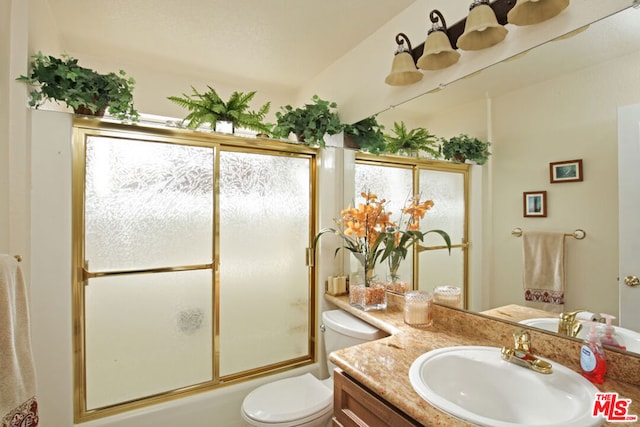 full bathroom with toilet, a wealth of natural light, enclosed tub / shower combo, and vanity