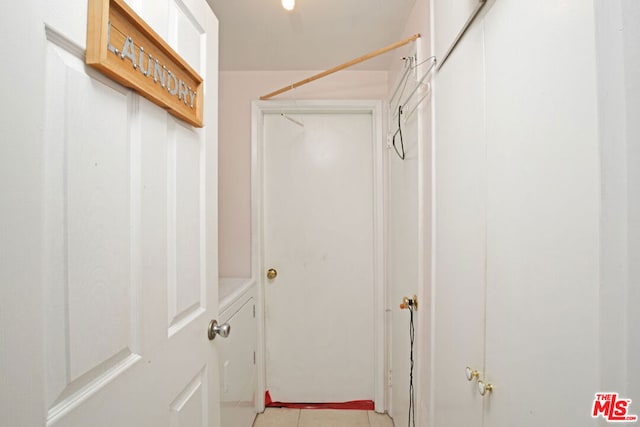 walk in closet featuring light tile patterned flooring