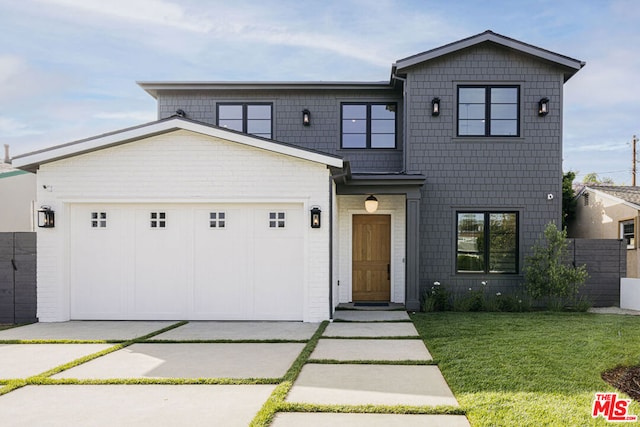 view of front of home featuring a front lawn and a garage