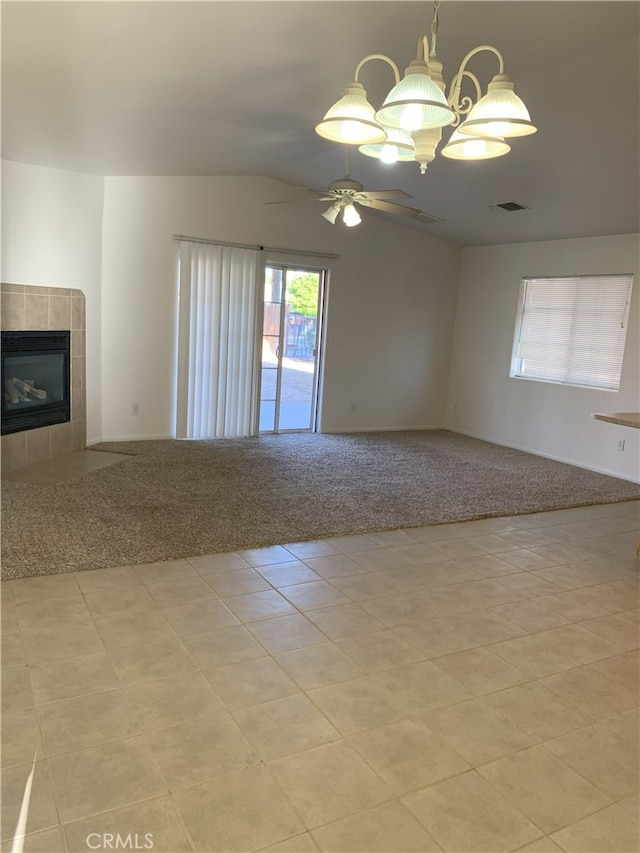 unfurnished living room featuring light carpet, a fireplace, and ceiling fan with notable chandelier