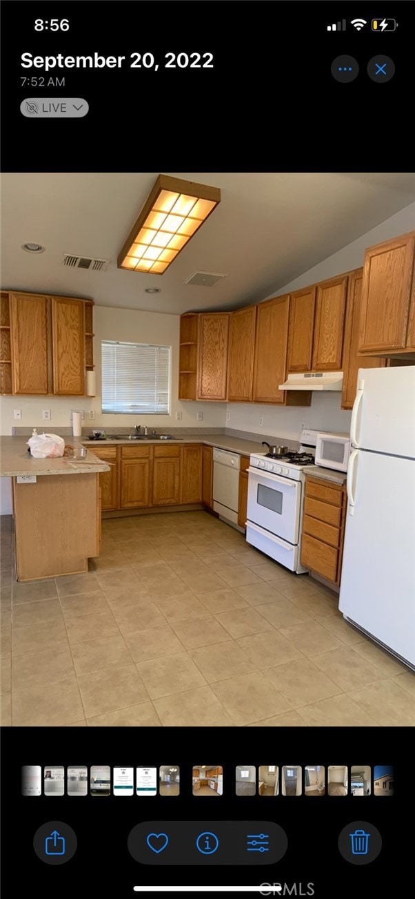 kitchen with sink, white appliances, and light tile patterned floors