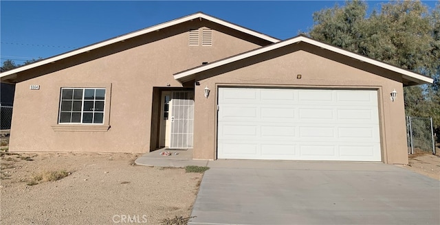 ranch-style home featuring a garage