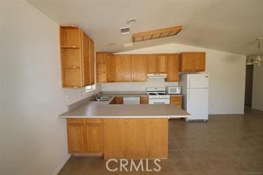 kitchen featuring extractor fan, kitchen peninsula, white appliances, vaulted ceiling, and sink