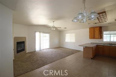 kitchen featuring ceiling fan, kitchen peninsula, and tile patterned floors