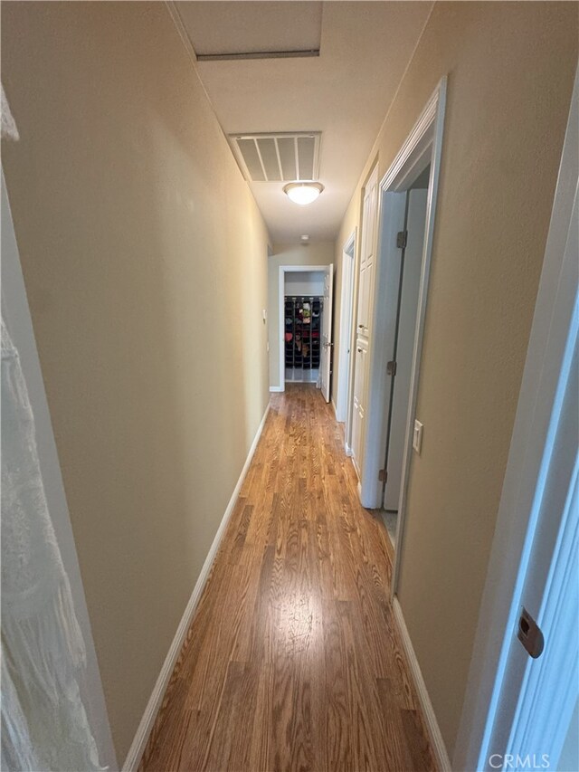 corridor with light hardwood / wood-style flooring