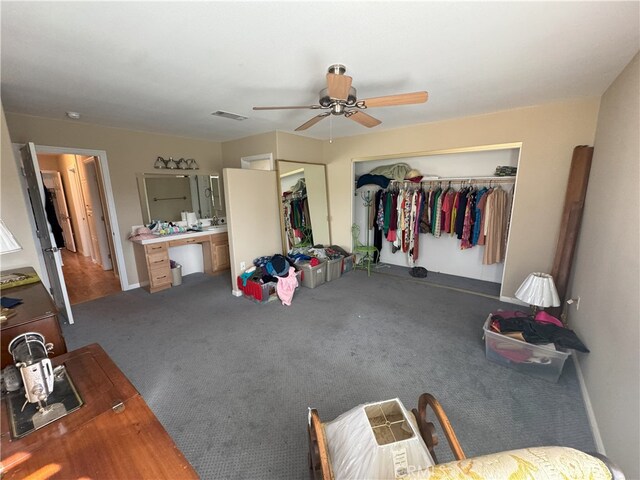 bedroom featuring ceiling fan, a closet, and carpet flooring