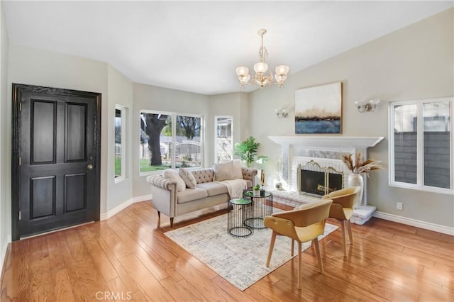 living room featuring light hardwood / wood-style flooring and a notable chandelier