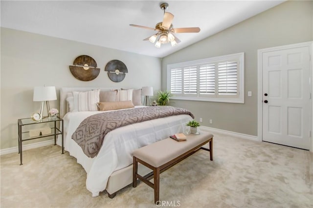 bedroom featuring ceiling fan, light carpet, and vaulted ceiling