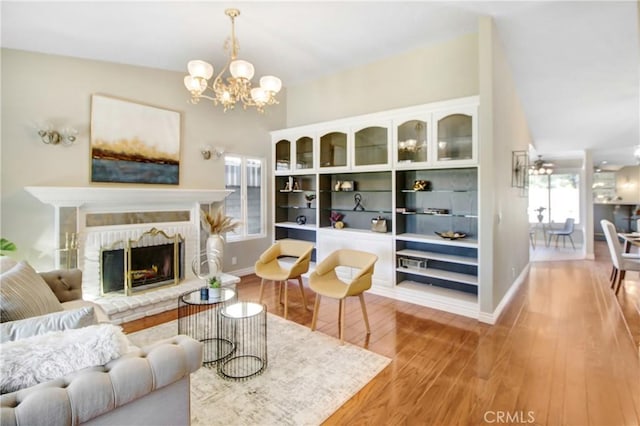 living room featuring a chandelier and light wood-type flooring