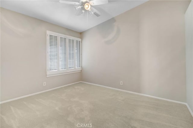 empty room featuring light carpet and ceiling fan