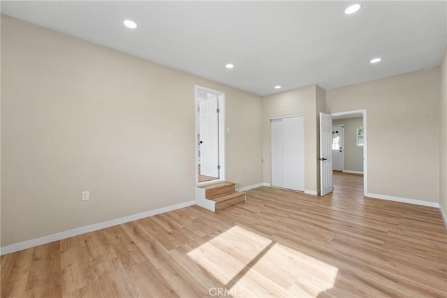 unfurnished bedroom with a closet and light hardwood / wood-style flooring