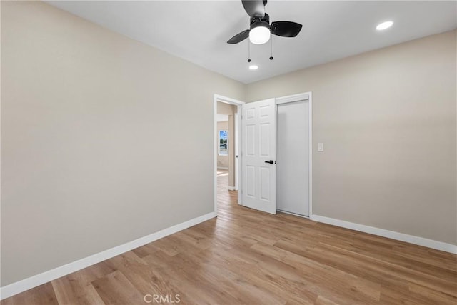 unfurnished bedroom with ceiling fan, light hardwood / wood-style flooring, and a closet