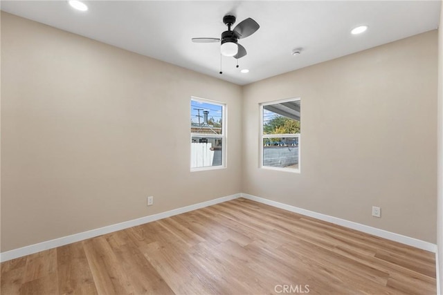 empty room featuring ceiling fan and light hardwood / wood-style floors