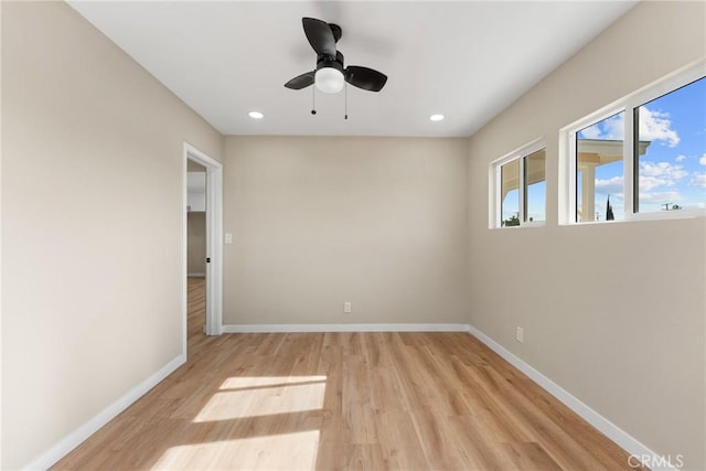 spare room featuring ceiling fan and light wood-type flooring