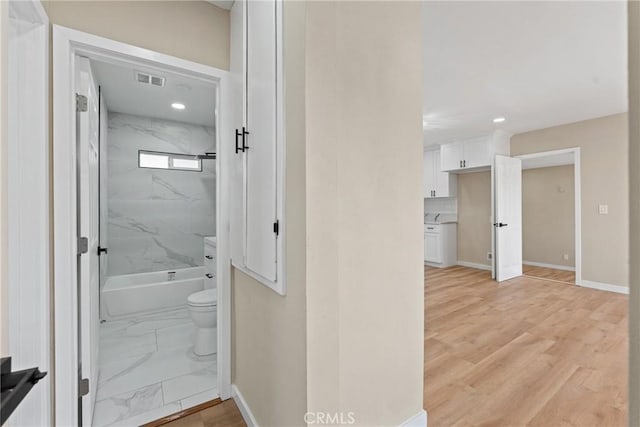 bathroom featuring toilet and hardwood / wood-style floors