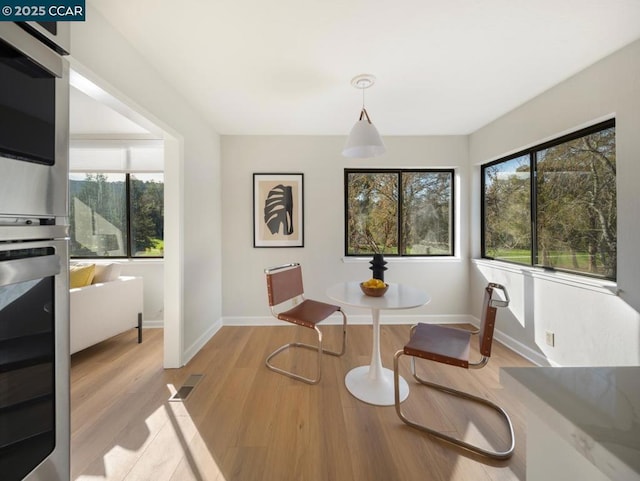 dining space featuring light wood-type flooring