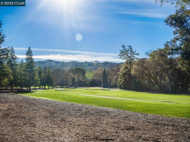 surrounding community featuring a mountain view and a lawn