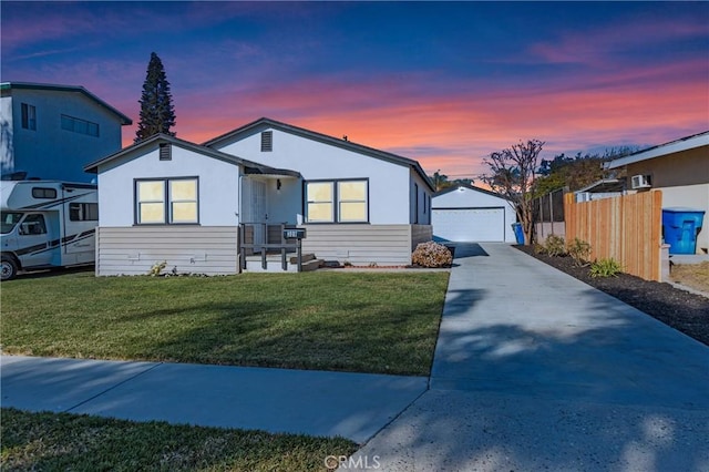 view of front of home featuring a garage, a yard, and an outdoor structure