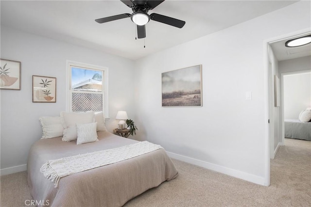 bedroom featuring ceiling fan and light carpet