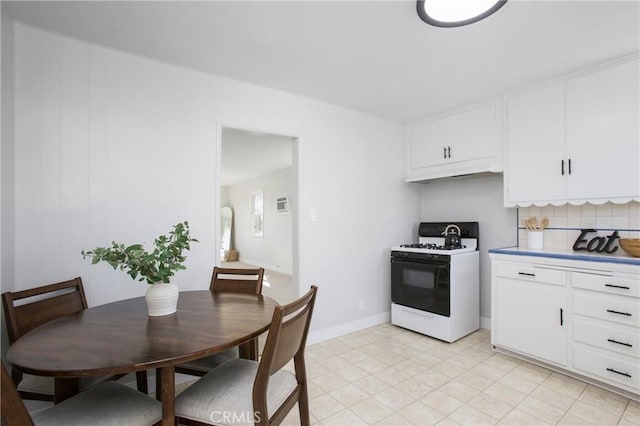 kitchen featuring white cabinetry, range with gas cooktop, and tasteful backsplash