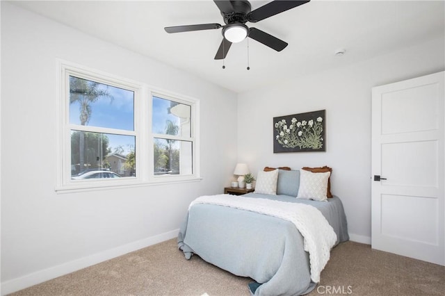 bedroom featuring ceiling fan and light carpet