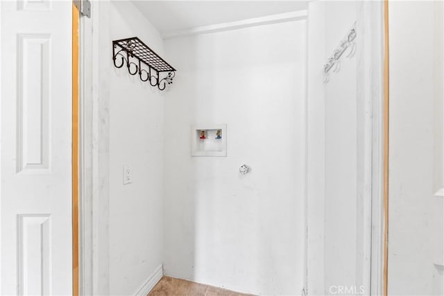 clothes washing area featuring light tile patterned floors and hookup for a washing machine