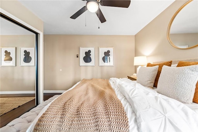 bedroom with ceiling fan, a closet, and wood-type flooring