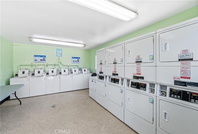 laundry area with stacked washer and clothes dryer and washing machine and clothes dryer