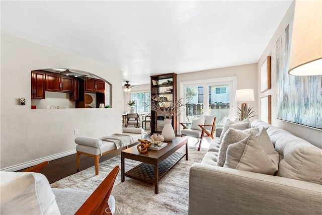 living room with light hardwood / wood-style floors and ceiling fan