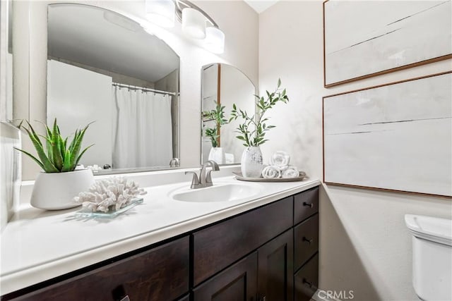 bathroom featuring toilet and vanity