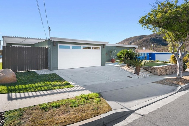 ranch-style house featuring a garage and a mountain view