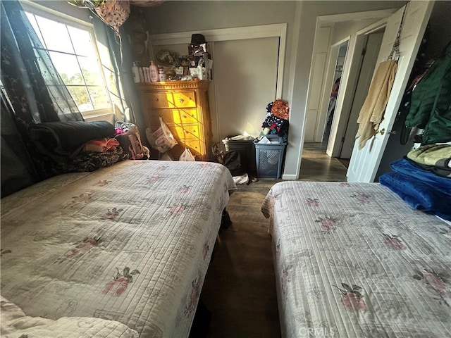 bedroom featuring a closet and dark hardwood / wood-style flooring