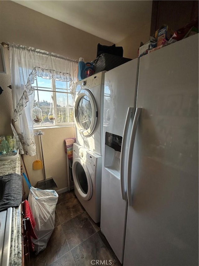 laundry room with stacked washer / drying machine